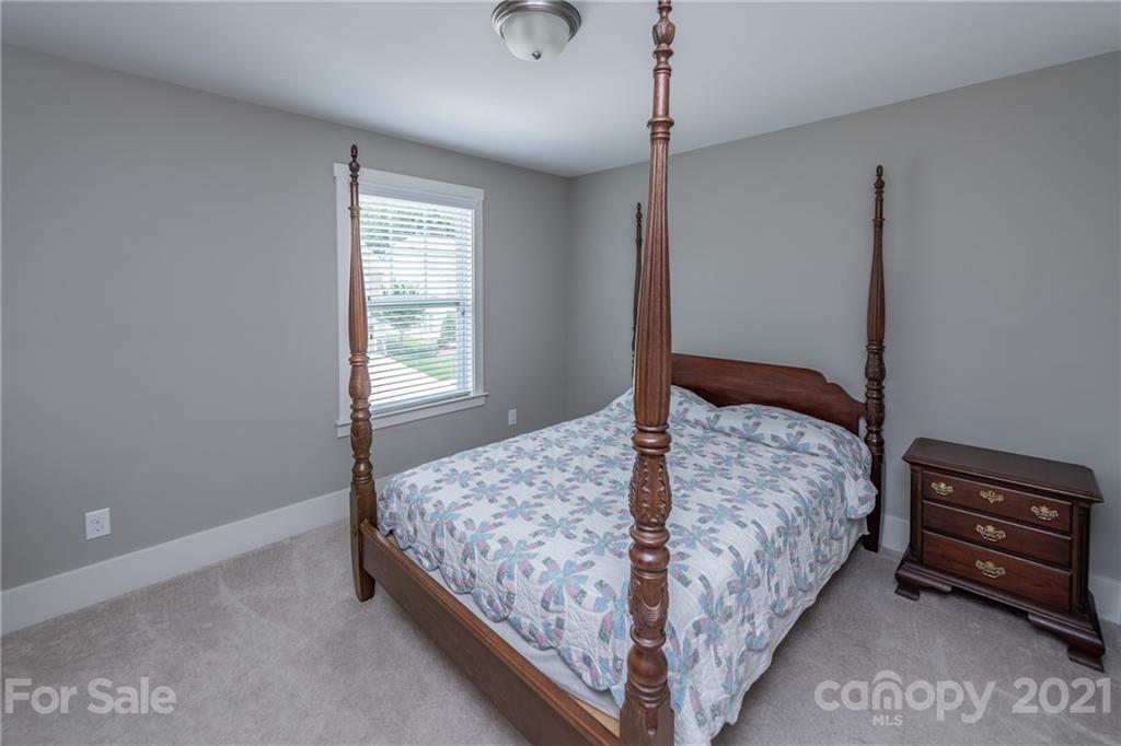 2142 Bluebell Way Tega Cay, SC 29708 - Photo 32 of 48 a bedroom with a bed and a window