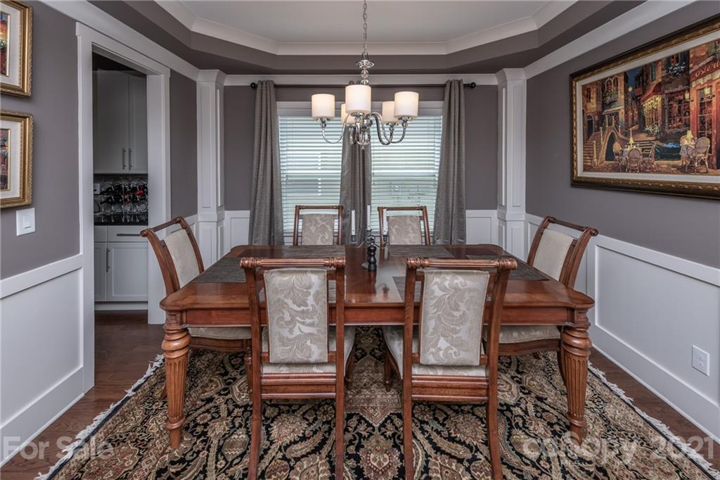 2142 Bluebell Way Tega Cay, SC 29708 - Photo 6 of 48 a view of a dining room with furniture a chandelier and wooden floor