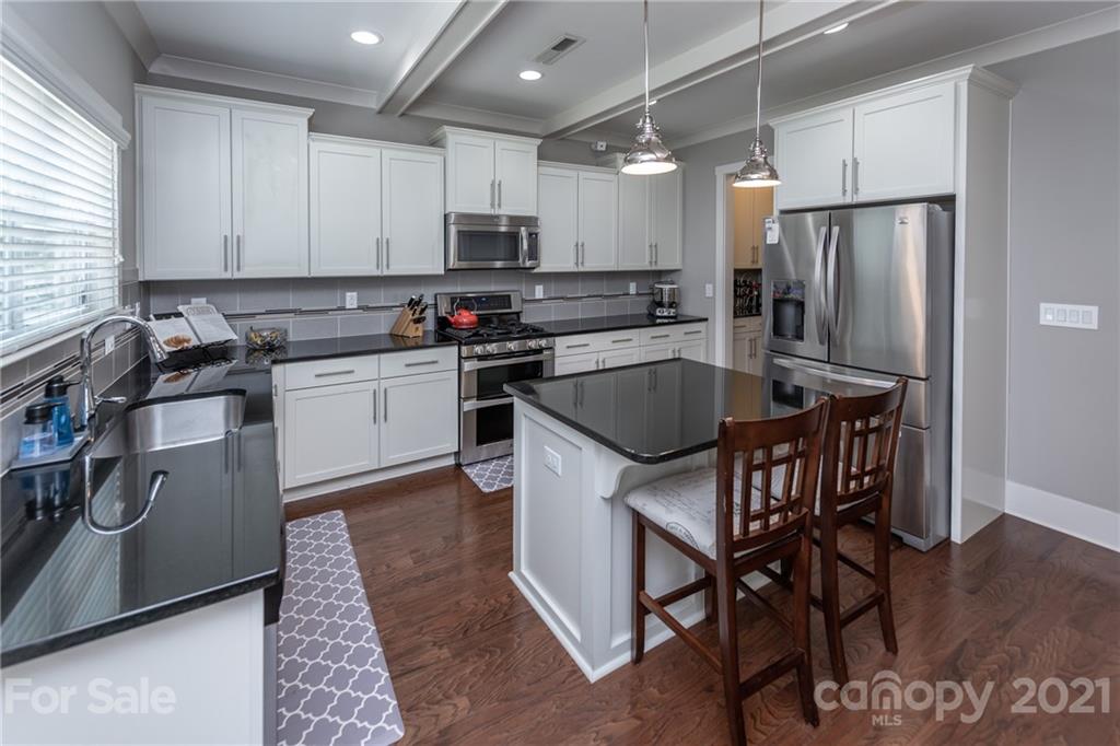 2142 Bluebell Way Tega Cay, SC 29708 - Photo 9 of 48 a kitchen with stainless steel appliances granite countertop a sink a stove a refrigerator and cabinets