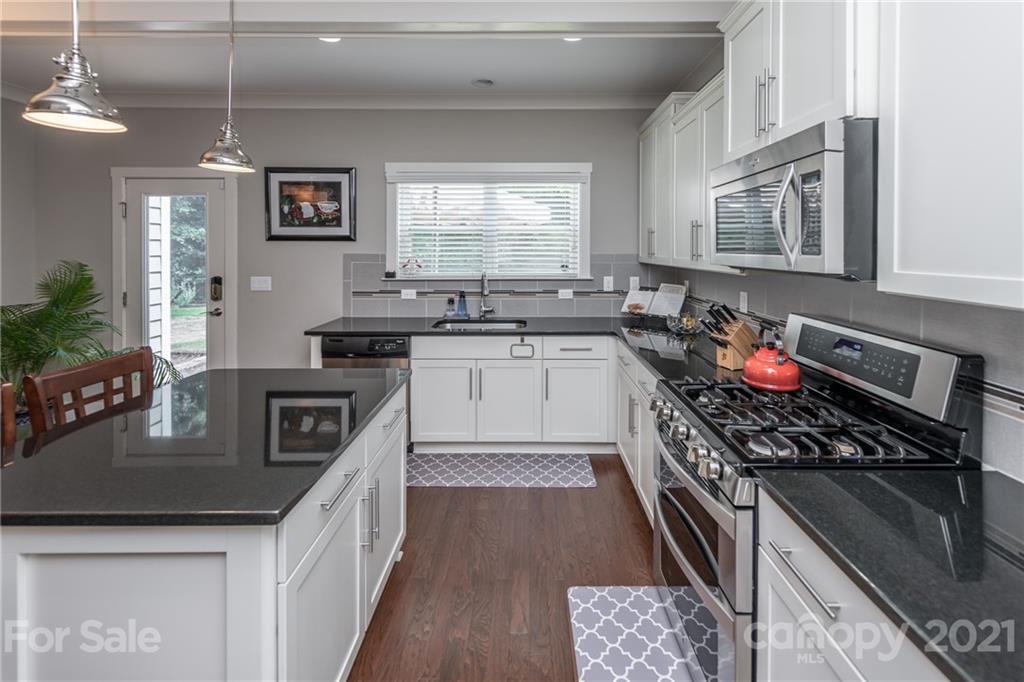 2142 Bluebell Way Tega Cay, SC 29708 - Photo 10 of 48 a kitchen with stainless steel appliances granite countertop a sink stove and refrigerator