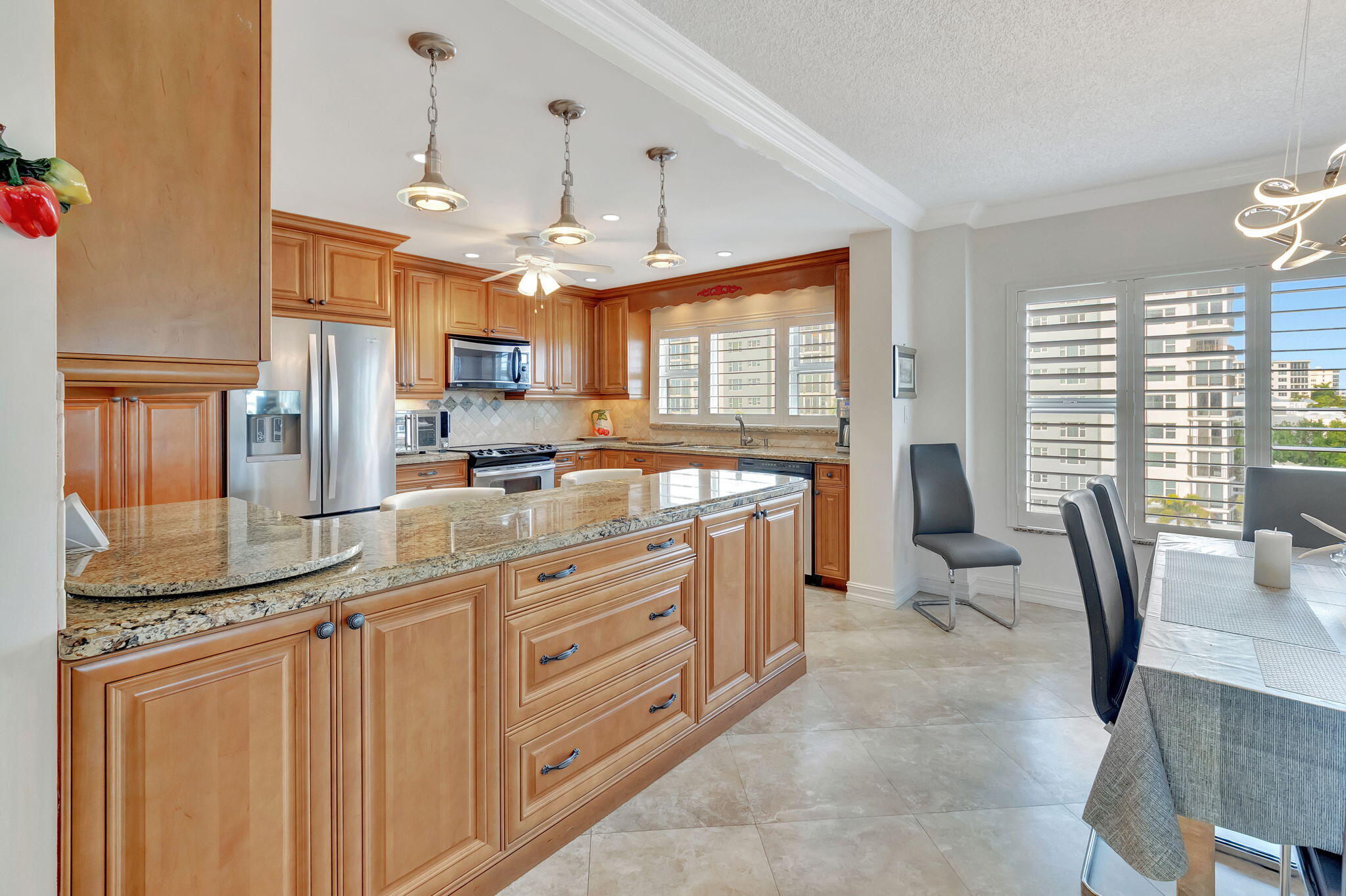 220 Mac Farlane Drive, Unit S505 Delray Beach, FL 33483 - Photo 19 of 72 a kitchen with stainless steel appliances kitchen island granite countertop a sink and cabinets