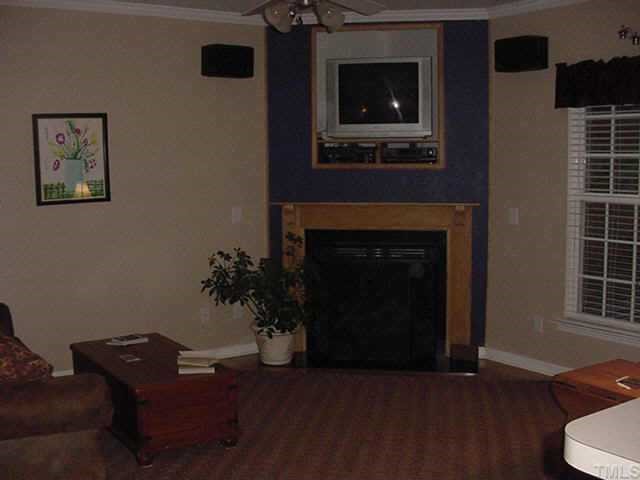 8417 Aztec Dawn Court Raleigh, NC 27613 - Photo 4 of 10 a living room with furniture and a fireplace