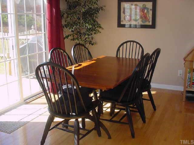 8417 Aztec Dawn Court Raleigh, NC 27613 - Photo 5 of 10 a view of a dining room with furniture window and wooden floor