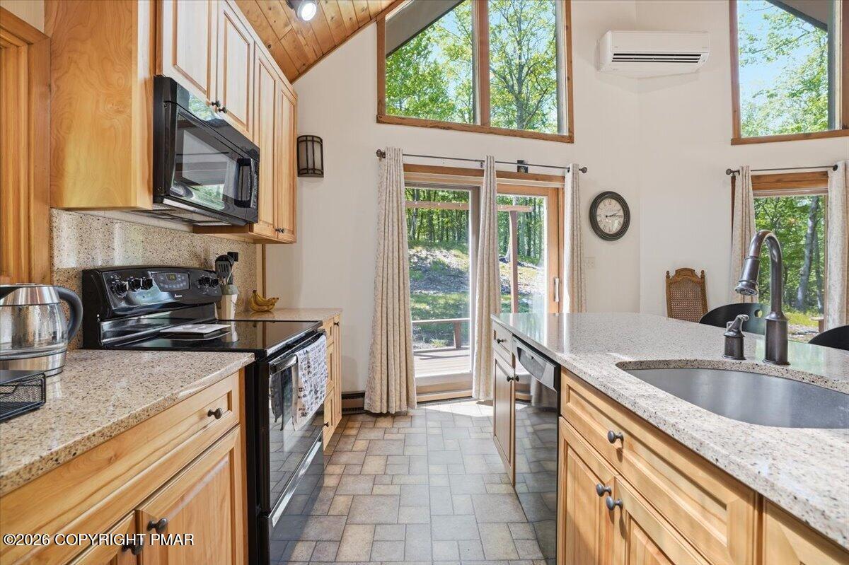 1517 Deer Run East Bushkill, PA 18324 - Photo 21 of 42 a kitchen with stainless steel appliances granite countertop a sink stove and refrigerator