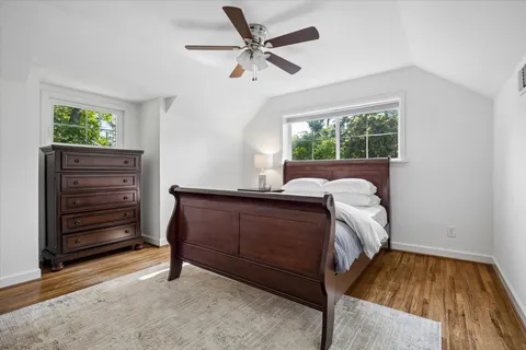 a bed sitting in a room next to a window