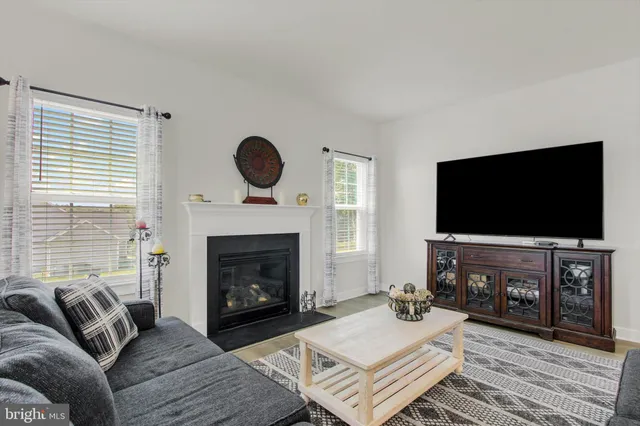 a living room with furniture a fireplace with wooden floor