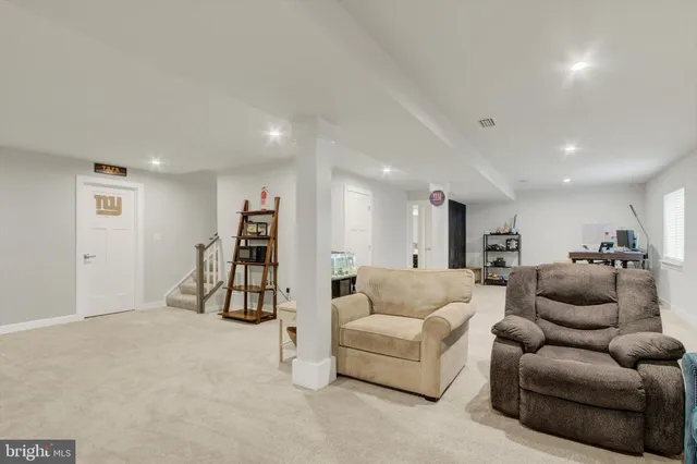 a view of a livingroom with furniture and staircase