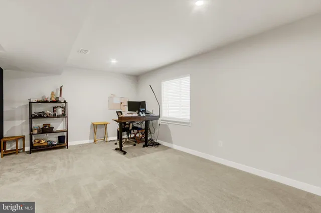 a living room with furniture and a gym with equipment