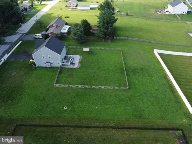 an aerial view of a house with a yard basket ball court and outdoor seating