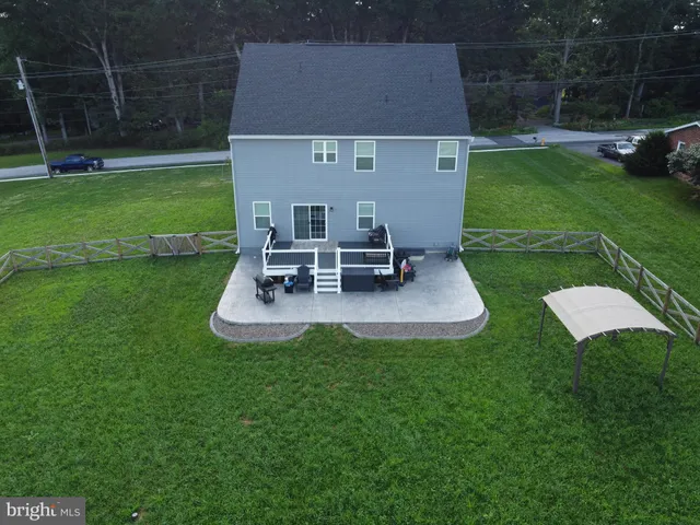 a view of a house with a backyard and a patio