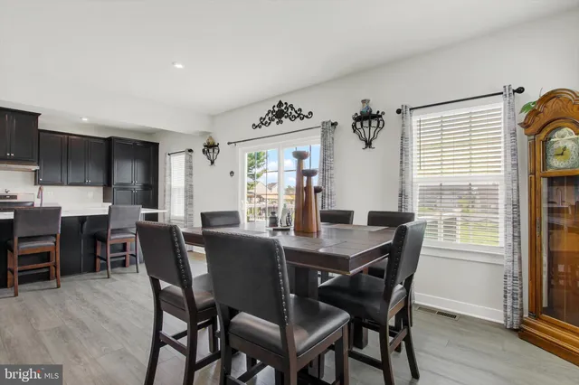 a large kitchen with a center island and stainless steel appliances