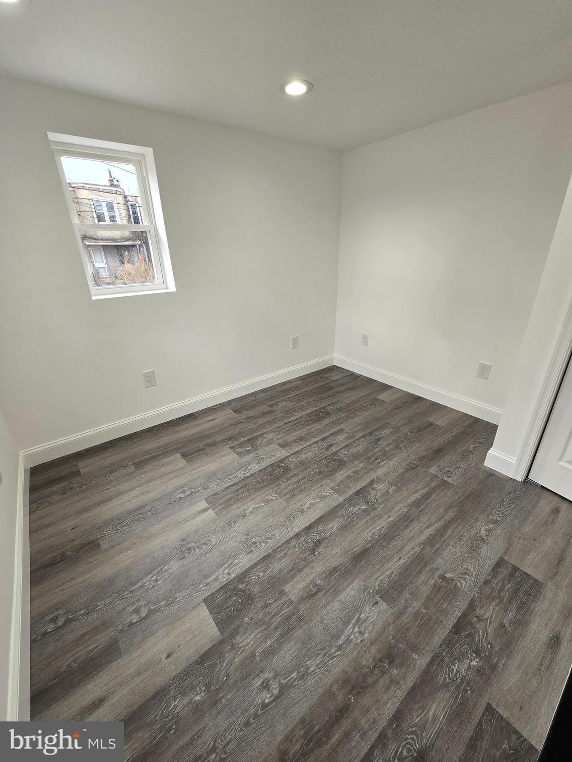 2008 Etting Street Baltimore, MD 21217 - Photo 14 of 22 an empty room with wooden floor and windows