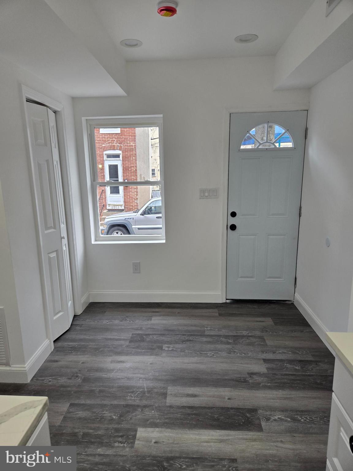 2008 Etting Street Baltimore, MD 21217 - Photo 2 of 22 a view of an empty room with wooden floor and a window
