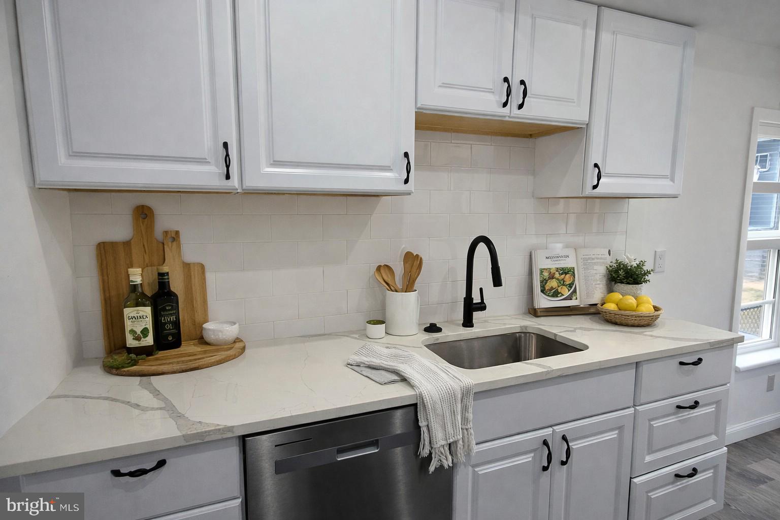 2008 Etting Street Baltimore, MD 21217 - Photo 6 of 22 a kitchen with stainless steel appliances granite countertop a sink a stove and white cabinets