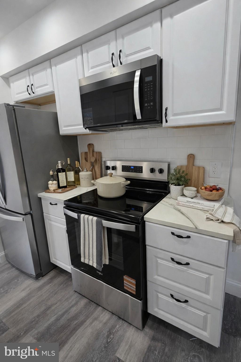 2008 Etting Street Baltimore, MD 21217 - Photo 7 of 22 a kitchen with stainless steel appliances a stove a microwave a sink and cabinets