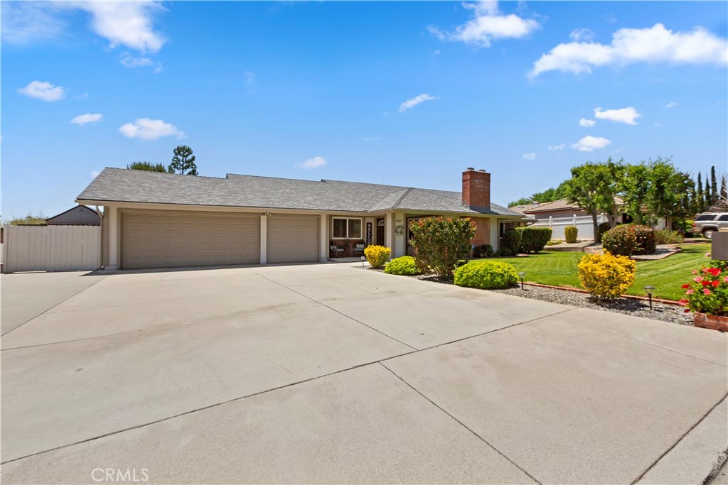 8527 Hillside Road Rancho Cucamonga, CA 91701 - Photo 3 of 50 a front view of a house with a yard and a garage