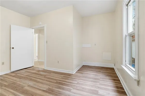 a view of a room with wooden floor and white doors