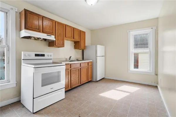 a kitchen with a stove a sink and a refrigerator