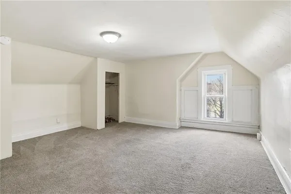 an empty room with windows and closet