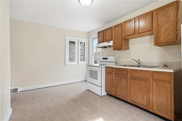 a kitchen with granite countertop white cabinets and white appliances