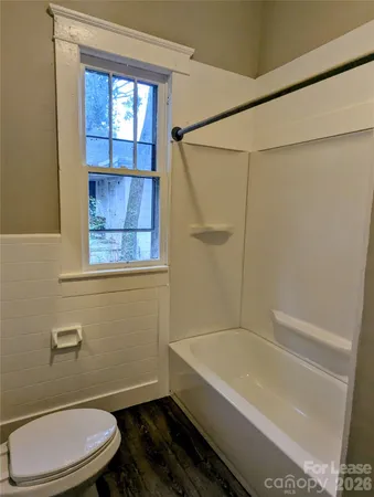 a bathroom with a toilet a sink and bathtub