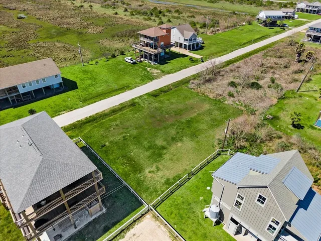 an aerial view of a house with a garden and trees