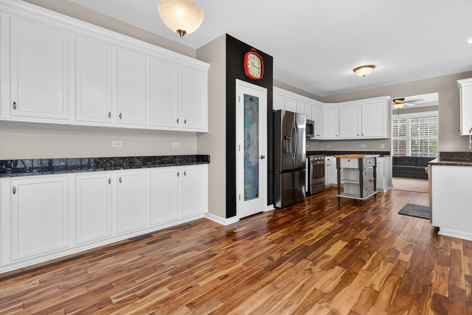 234 Longview Drive Elgin, IL 60124 - Photo 12 of 37 a kitchen with granite countertop white cabinets and stainless steel appliances