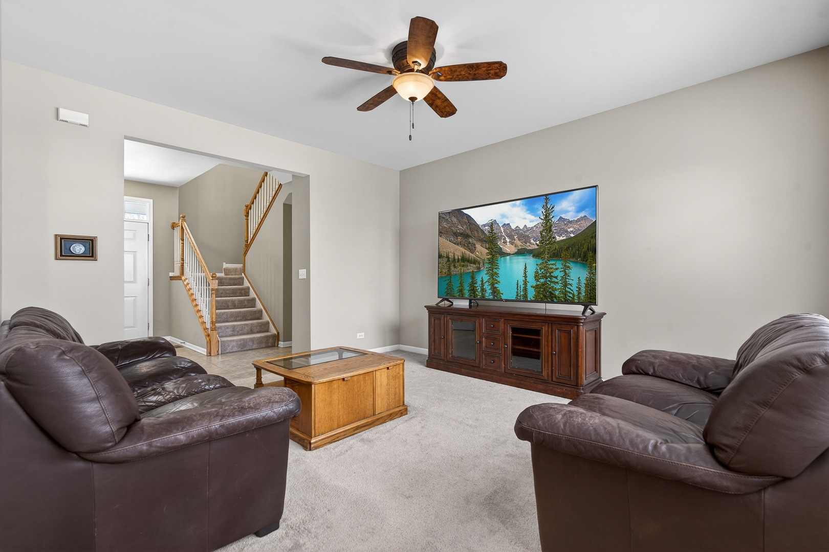 234 Longview Drive Elgin, IL 60124 - Photo 5 of 37 a living room with furniture a ceiling fan and a window