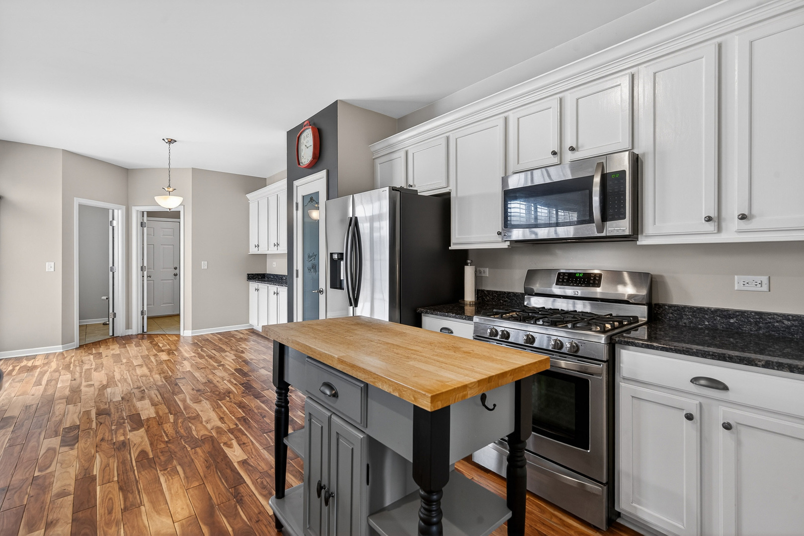 234 Longview Drive Elgin, IL 60124 - Photo 9 of 37 a kitchen with a stove a refrigerator and a microwave