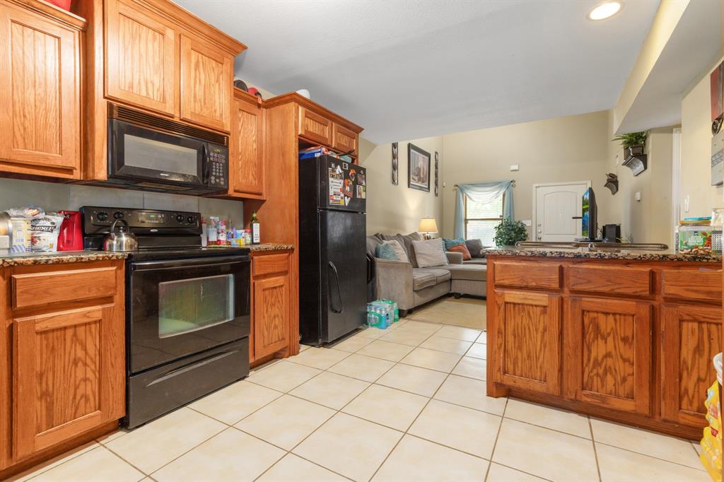 20 Addi Lane Waco, TX 76705 - Photo 24 of 24 a kitchen with stainless steel appliances granite countertop a stove top oven microwave and cabinets