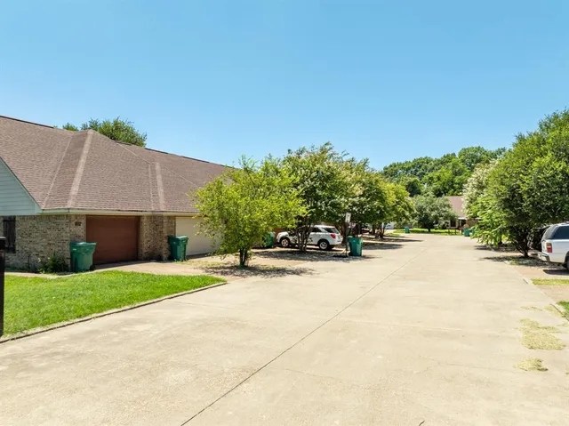 a view of a house with a yard and tree