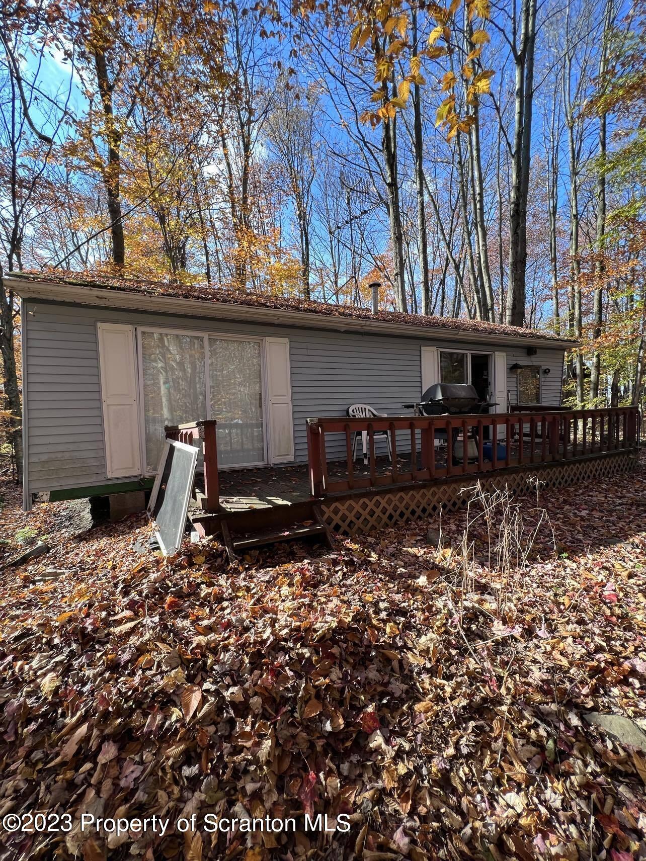 31 Blue Sky Path Gouldsboro, PA 18424 - Photo 2 of 12 a backyard of a house with barbeque oven and table