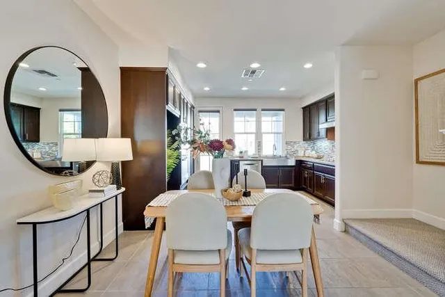 a dining room with furniture a mirror and a chandelier