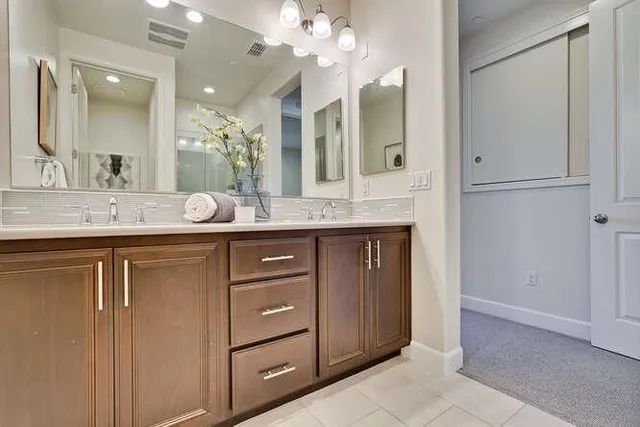 a bathroom with a granite countertop sink and a mirror