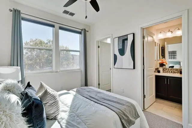 a bedroom with a bed and a large mirror