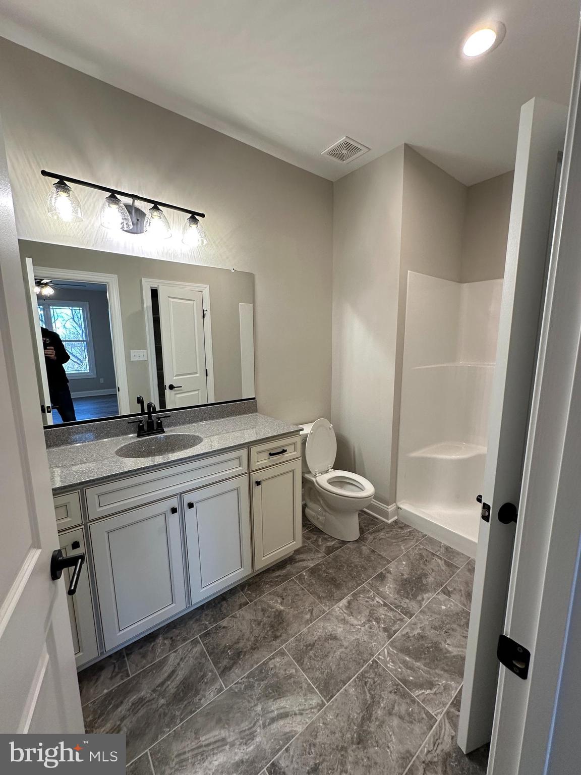 7 Redbud Road Winchester, VA 22603 - Photo 21 of 25 a spacious bathroom with a double vanity sink a toilet and a mirror