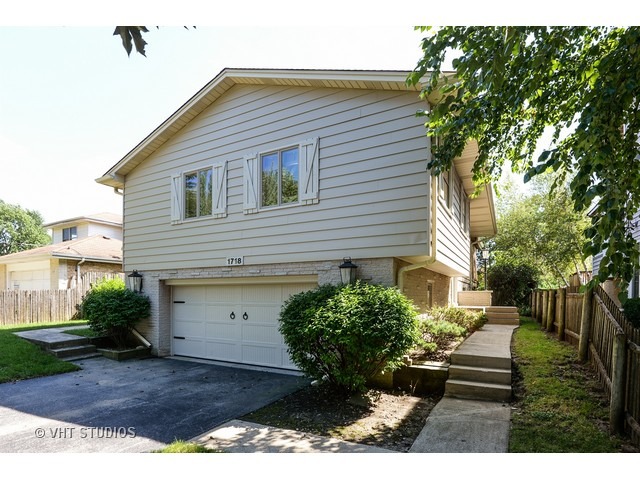 1718 Harding Road Northfield, IL 60093 - Photo 1 of 10 a front view of a house with a yard