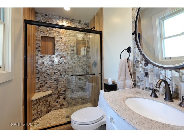 1718 Harding Road Northfield, IL 60093 - Photo 6 of 10 a bathroom with a sink a toilet and a mirror