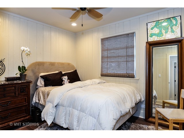 1718 Harding Road Northfield, IL 60093 - Photo 8 of 10 a bedroom with a bed and a chandelier