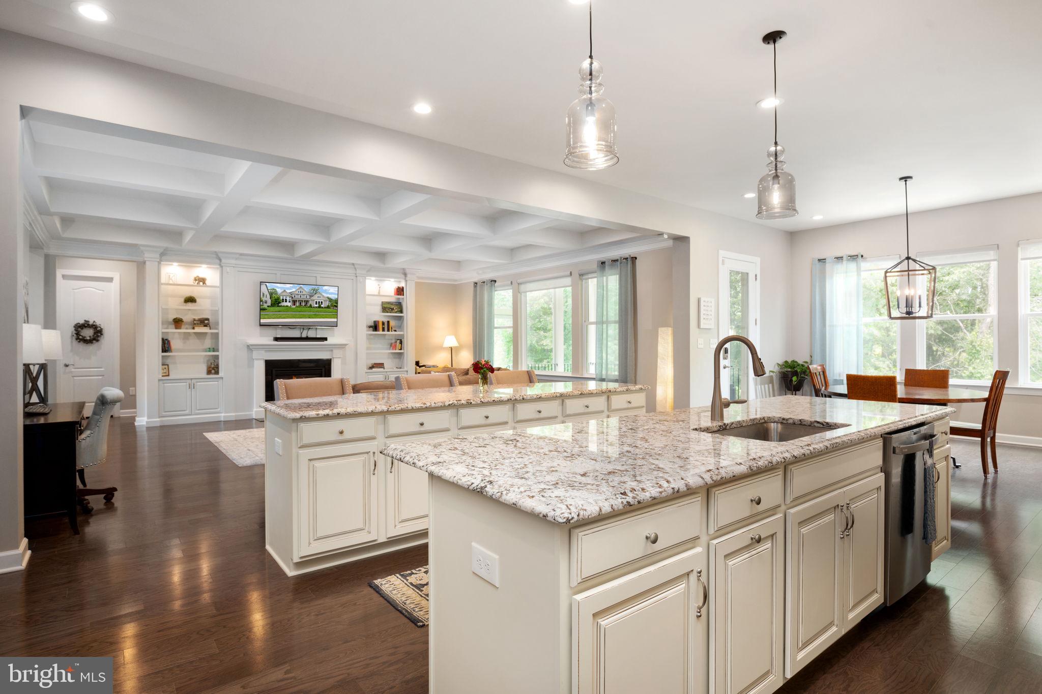 a kitchen with center island white cabinets and couches