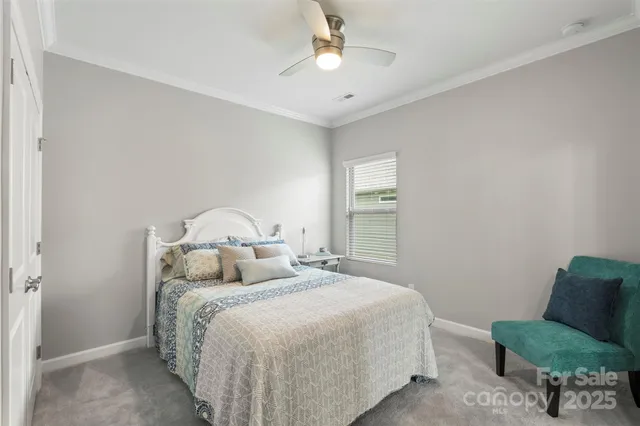 a bedroom with a bed window and a chair