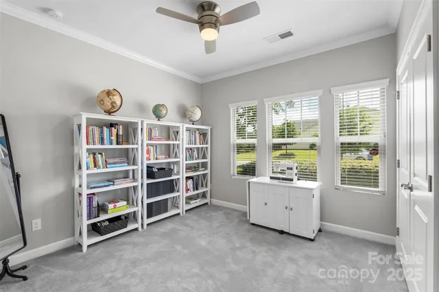 an empty room with bookshelf and a window