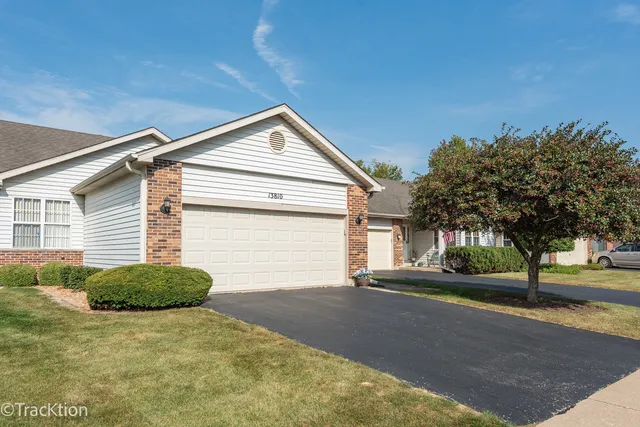 a view of a house with a yard and garage