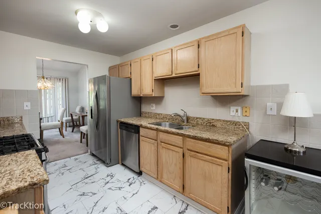 a kitchen with stainless steel appliances granite countertop a stove and a microwave
