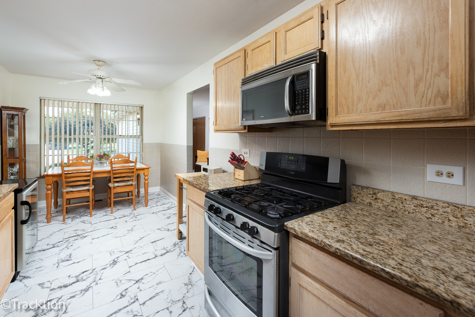13810 Magnolia Drive Plainfield, IL 60544 - Photo 10 of 30 a kitchen with stainless steel appliances granite countertop a stove and a microwave