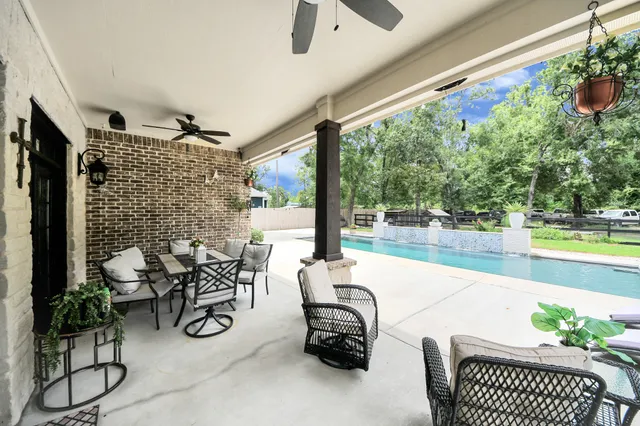 a view of a patio with table and chairs and potted plants