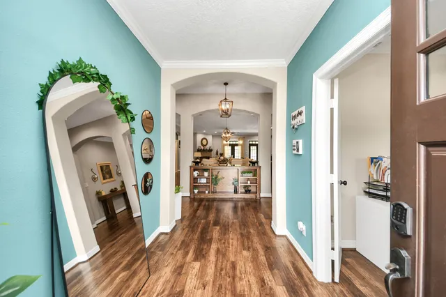 a view of entryway with wooden floor and mirror