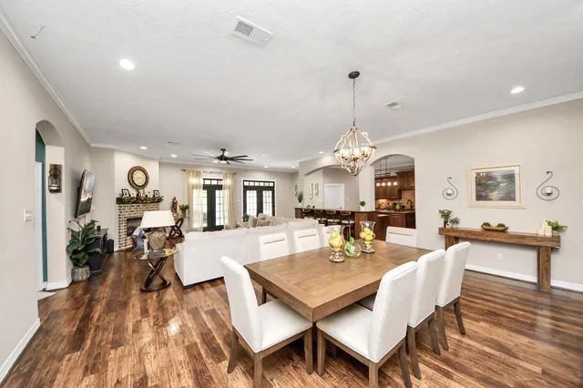 a living room with fireplace furniture and a potted plant