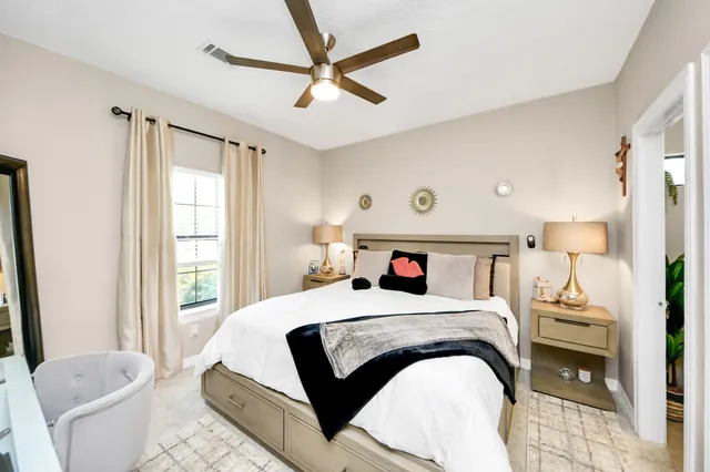 a room with a bed furniture and a flat screen tv