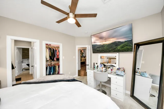 a bathroom with a granite countertop sink a mirror and shower